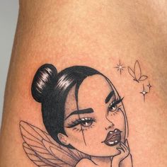 a woman's thigh with an angel tattoo on it