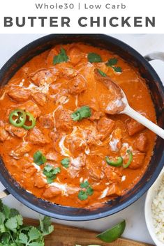 an image of a bowl of chicken curry with rice and cilantro on the side