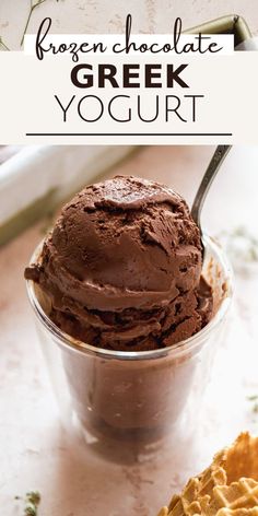 chocolate greek yogurt in a glass bowl with a spoon and crackers on the side