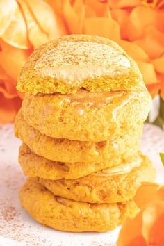 a stack of cookies sitting next to orange flowers