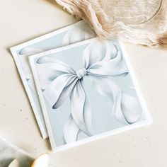 a card with a white bow on it