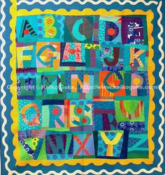 a colorful quilt with letters and numbers on it