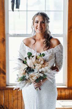 a woman in a wedding dress holding a bouquet