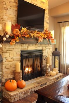 a living room with a fire place and television on the fireplace mantel, decorated for fall