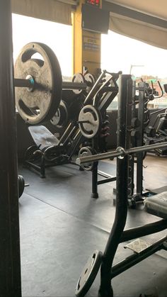 an empty gym with heavy equipment in the background