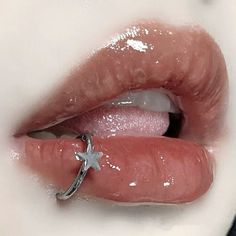 a close up of a person's lips with a ring on their lip and the nose