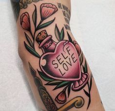 a tattoo on the leg of a person with a heart shaped bottle that says self love