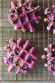 some kind of waffles with sprinkles on them sitting on a cooling rack