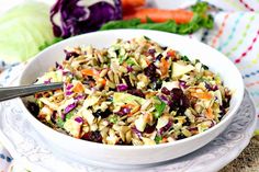 a white bowl filled with coleslaw and carrots on top of a table