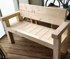 a wooden bench sitting on top of a hard wood floor next to a bike rack