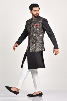 Black bundi with mandarin collar, patch pocket, all over geometric pattern, multi color thread, zari and sequin embroidery. Paired with full sleeve kurta with all over abstract woven pattern and white straight pant.
Components: 3
Pattern: Hand Embroidered and Woven
Type Of Work: Thread, Zari, Sequin Work and Abstract Pattern
Neckline: Mandarin Collar
Sleeve Type: Bundi: Sleeveless, Kurta: Full Sleeves
Fabric: Crepe, Handloom Silk, Terry Rayon
Color: Black
Other Details: 
Embellished buttons
Fron Full Sleeve Kurta, Sleeveless Kurta, Embellished Buttons, Kurta Set For Men, Tarun Tahiliani, Sequin Embroidery, Nehru Jackets, Woven Pattern, Black Thread