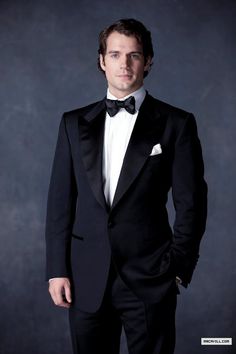 a black and white photo of a man in a tuxedo