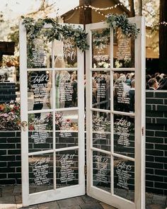 an open glass door with chalkboard menus on the front and side panels that say it all