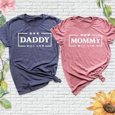 Welcome to my Etsy shop! Mommy Daddy Est Shirt, Baby Announcement Tshirt, Mom and Dad Shirts, New Mommy Gifts, Matching Couples Pregnancy Tee, Wife and Husband Shirt. Wife and Husband Tee Matching Couples Tee Mommy Daddy Est Tee Mom Dad Est Shirt Wifey Hubby Shirt New Dad Shirt New Parent Shirt Mom Announcement Tee Custom Mom Dad Shirt. Mommy Daddy Est Shirt - Celebrate your growing family with this custom Mommy Daddy Est Shirt, perfect for making your Baby Announcement extra special. These Mom and Dad Shirts are designed for new parents, making them a thoughtful choice for New Mommy Gifts. Whether you're sharing your exciting news or just want to cherish the moment, this Matching Couples Pregnancy Tee is a great way for wife and husband to celebrate together. A heartfelt keepsake, this Wi Mommy Daddy Shirt, Pregnancy Announcement Shirts For Family, Mom And Dad Shirts, Mom And Dad Shirts Pregnancy, Maternity Family Matching T-shirt With Graphic Print, Hubby Wifey Shirts, New Mommy Gifts, Wife And Husband, Mom Dad Baby