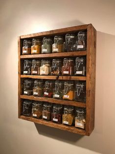 a wooden shelf with jars and labels on it