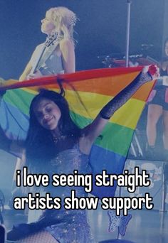 a woman holding a rainbow flag with the words i love seeing straight artists show support