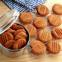 several cookies and a cookie tin on a table