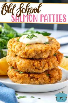 three crab cakes stacked on top of each other with lemon wedges and parsley