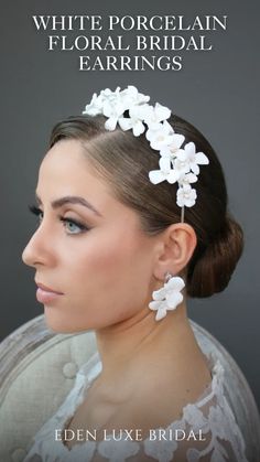 a woman with white flowers in her hair and the words, white porcelain floral earrings