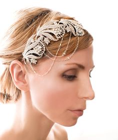 a woman wearing a head piece with chains on it's forehead and hair comb in the shape of leaves