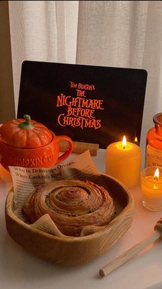 a table topped with candles and cinnamon rolls