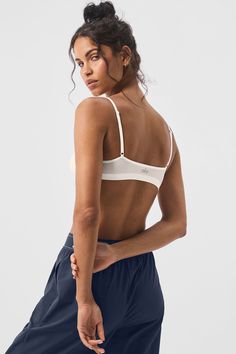 You’ll swear by this bralette—it’s made from our newest fabric, so it’s buttery-soft, lightly supportive, and seriously stretchy. It has a simple silhouette, a scoop neck, and skinny, adjustable straps. As for the second-skin fit, it prevents digging or pinching and ensures a smooth look while layering. Everyday Compressive Sports Bra With Built-in Bra, Chic Seamless Camisole Intimate, Everyday Stretch Sports Bra With Scoop Neck, Everyday Seamless Scoop Neck Bra, White Bra With Built-in Support And Micro-elastic Fit, Everyday Camisole Sports Bra, Everyday Seamless Crop Top, Seamless Scoop Back Crop Top, Chic Sports Bra With Built-in Bra For Workout