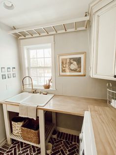 a kitchen with white cabinets and a sink