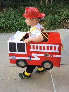 a small child in a fire truck costume