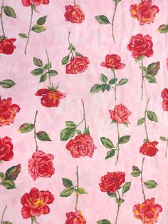 a pink background with red roses and green leaves