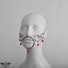 'DRIBBLE' mask in red. The rings and hoops across the cheeks meet in a large ring around the mouth. Fastening with chain adjuster at the back. 1-4 weeks to make and ship + transit time, or select 'rushed' to make and ship within 1 week (+ transit time, depending on shipping method). Adjustable Red Masks And Prosthetics For Masquerade, Costume Masks, Costume Mask, Large Ring, The Rings, Costume Accessories, The Selection, Mask, Style Inspiration