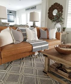 a living room filled with furniture and pillows