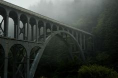 an old bridge in the fog on a cloudy day