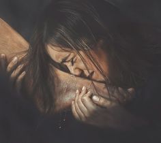 a woman is laying down with her hands on her chest and face covered in water