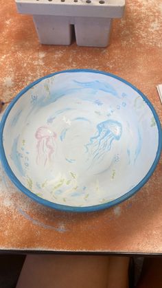 a blue and white bowl sitting on top of a table