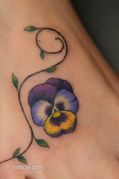 a flower tattoo on the side of a woman's stomach