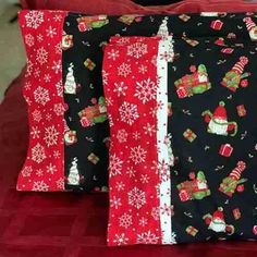 three christmas themed pillows sitting on top of a bed