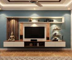 a living room with blue walls and wooden flooring has a buddha statue on the entertainment center