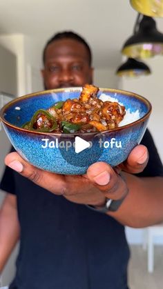 a man holding a bowl filled with food