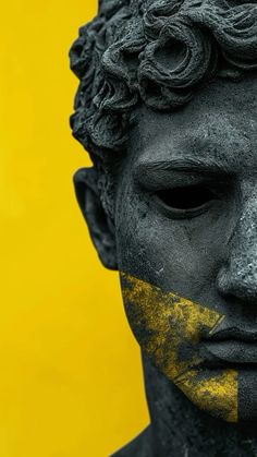 a man's face is covered in black and yellow paint