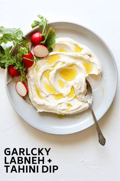 a white plate topped with food next to radishes