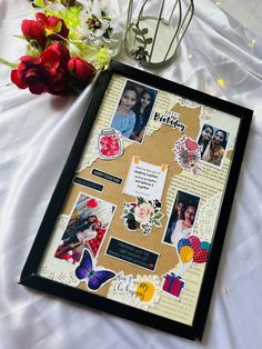 a collage of pictures and flowers on a white table cloth with a black frame