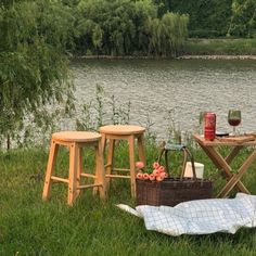 picnic table and stools by the water with food