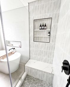 a bath room with a sink and a bath tub next to a stand up shower