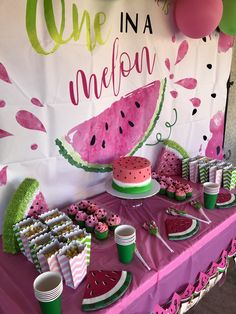 a watermelon themed birthday party with pink and green decorations, paper plates and cups