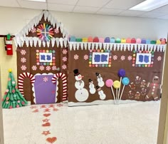 an office decorated for christmas with gingerbread houses and candy canes on the floor