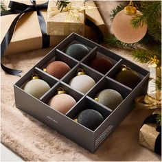 an open box with twelve ornaments in it