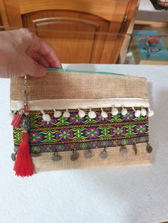 Nice handbag with silk thread tassel decoration and small imitation suede tassel that can be removed and put on, it is made of burlap and trimmings, seed beads and coins, it is light and comfortable, it also has a hand strap, super comfortable. Measurements: 25 x 18 x 2 cm. Thanks for visiting my little shop. ❤ Bohemian Clutch Bag With Tassels, Rectangular Clutch With Tassels For Daily Use, Bohemian Tassel Clutch Bag, Bohemian Clutch Shoulder Bag With Tassels, Rectangular Tassel Bags Perfect For Gifts, Bohemian Tassel Clutch Shoulder Bag, Bohemian Rectangular Clutch With Fringe, Rectangular Tasseled Bags As Gifts, Beige Bohemian Clutch Pouch