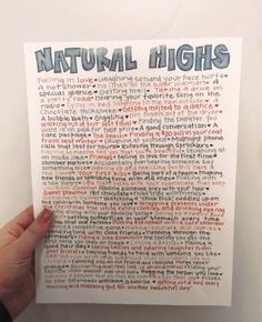 a hand holding up a piece of paper with writing on it that says natural highs