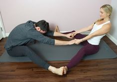 a man and woman are doing yoga together