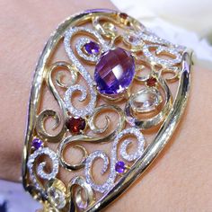 This stunning bangle has 171 round diamonds (1.64cts), 3 green amethysts (1.68cts), 3 garnites (0.63cts, and 4 purple amethysts (6.68cts). The diamonds are pave set, and the colored stones are prong set. All jewelry sales come with an appraisal including replacement value. For more visit our website: www.matineejewelryinc.com Luxury Gemstone Cuff Bracelet For Anniversary, Elegant Bangle With Gemstone Accents, Elegant Cuff Bracelet With Gemstone Accents, Elegant Gemstone Cuff Bracelet For Wedding, Luxury Wedding Bracelets With Gemstone Accents, Elegant Diamond Bangle With Gemstones, Elegant Multi-stone Cuff Bangle Bracelet, Elegant Multi-stone Bangle For Anniversary, Luxury Gemstone Cuff Bracelet For Weddings